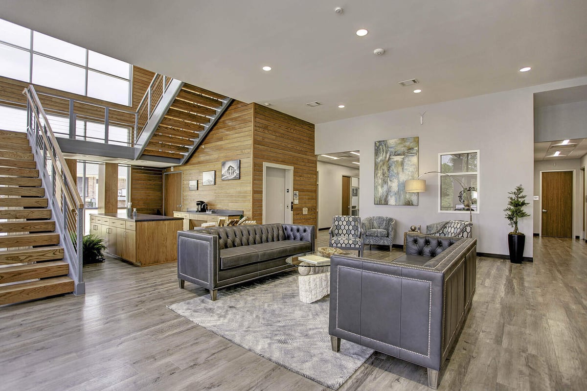 Elegant interior with modern staircase and open space in a renovated commercial property by GSD Construction, Houston, TX