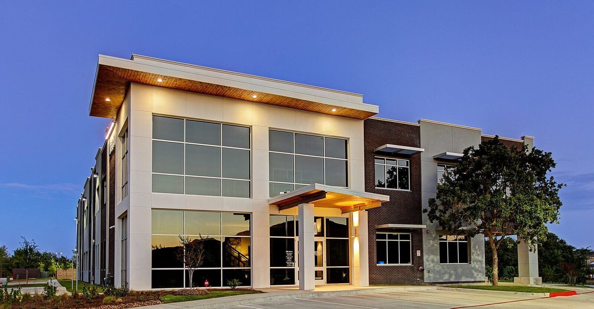 Illuminated exterior corridor of a renovated commercial property by GSD Construction in Houston, TX