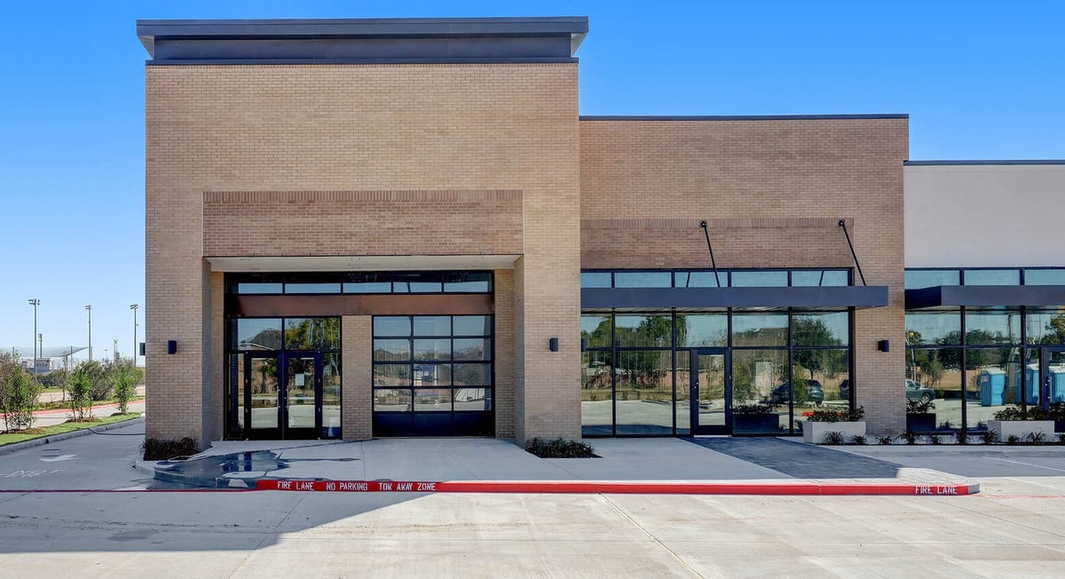 Front view of a newly developed commercial property with large windows and modern design in Houston, TX