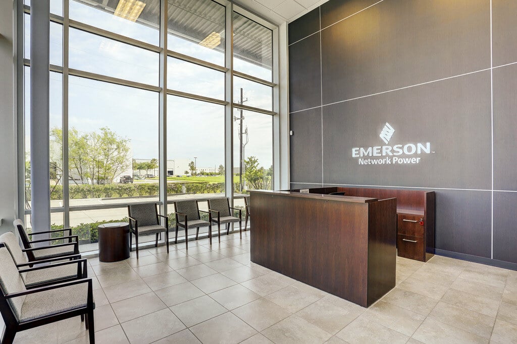 Modern reception area of Emerson Network Power office in Houston, TX, featuring sleek furniture and branding